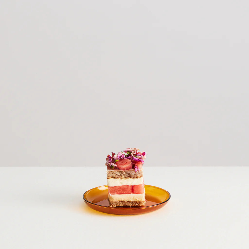 An amber coloured glass plate with a cake on top