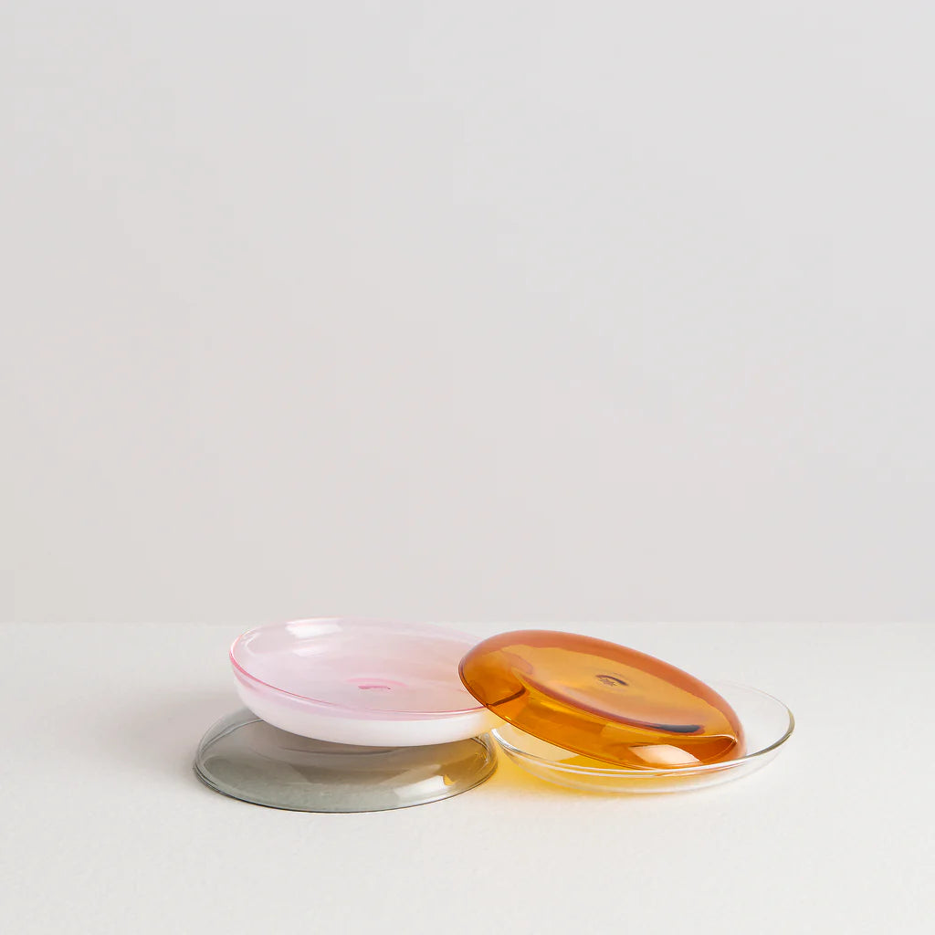 An assortment of glass plates in varying colours