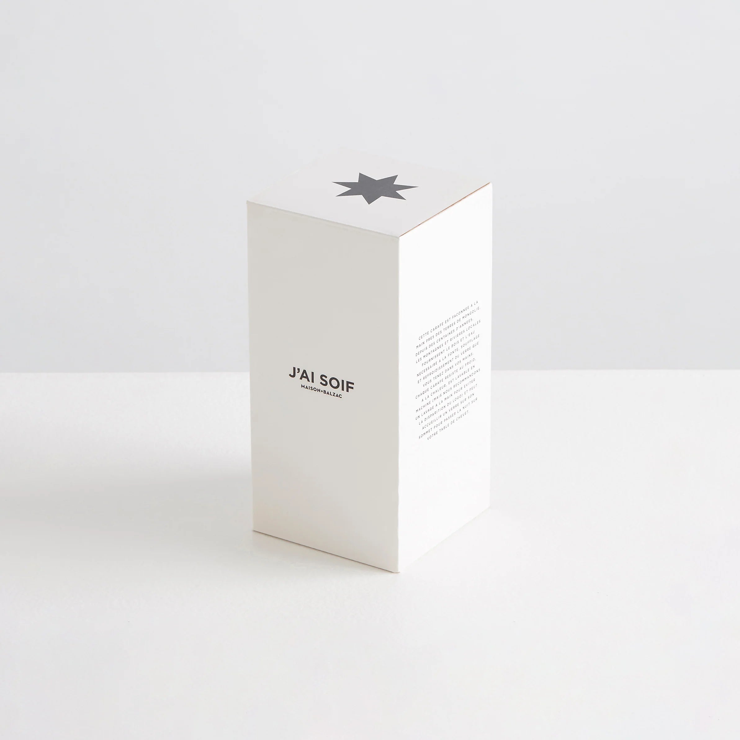 A white box with the words "J'ai Soif" printed along the front. Designed to hold the Maison Balzac carafe