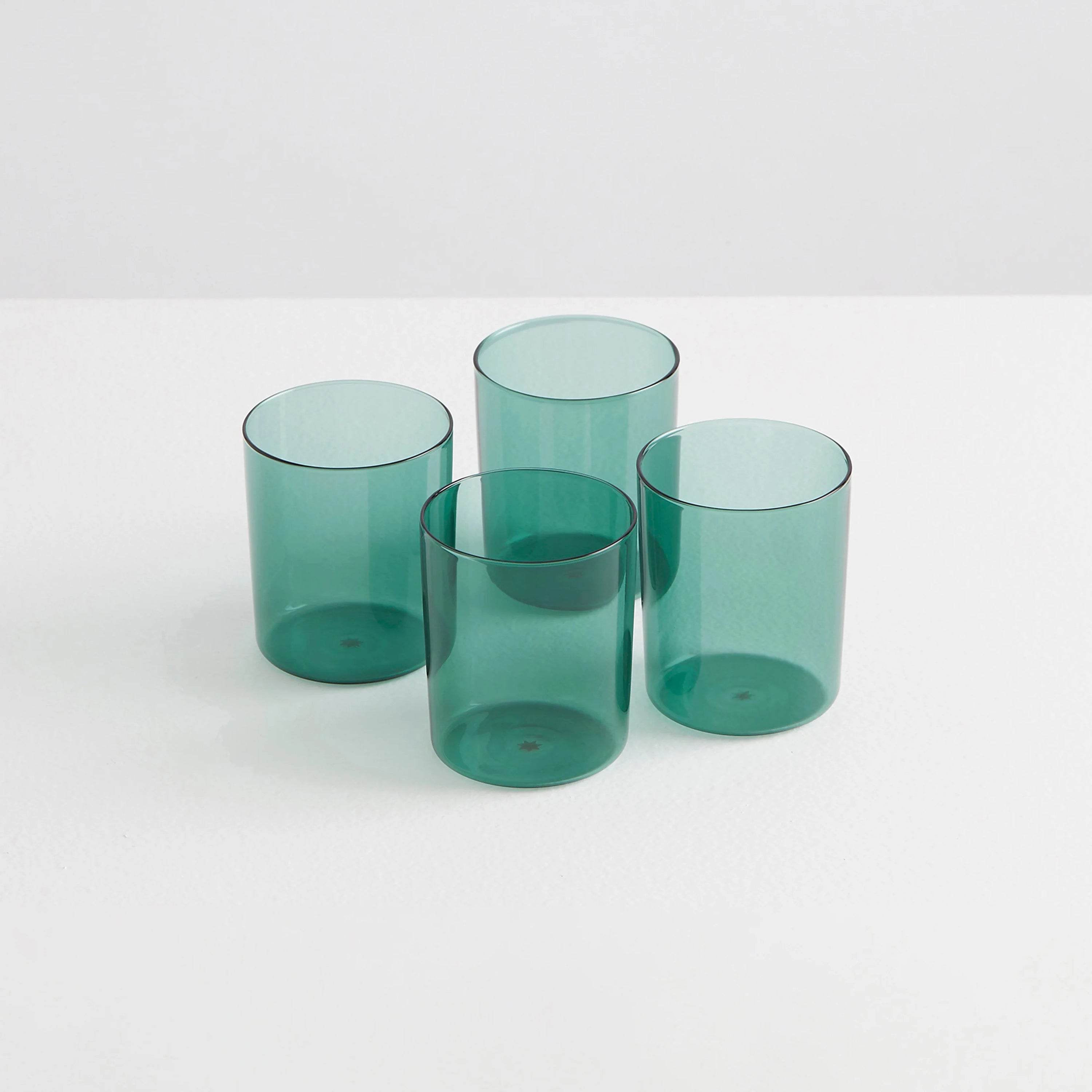 Four teal coloured clear drinking glasses