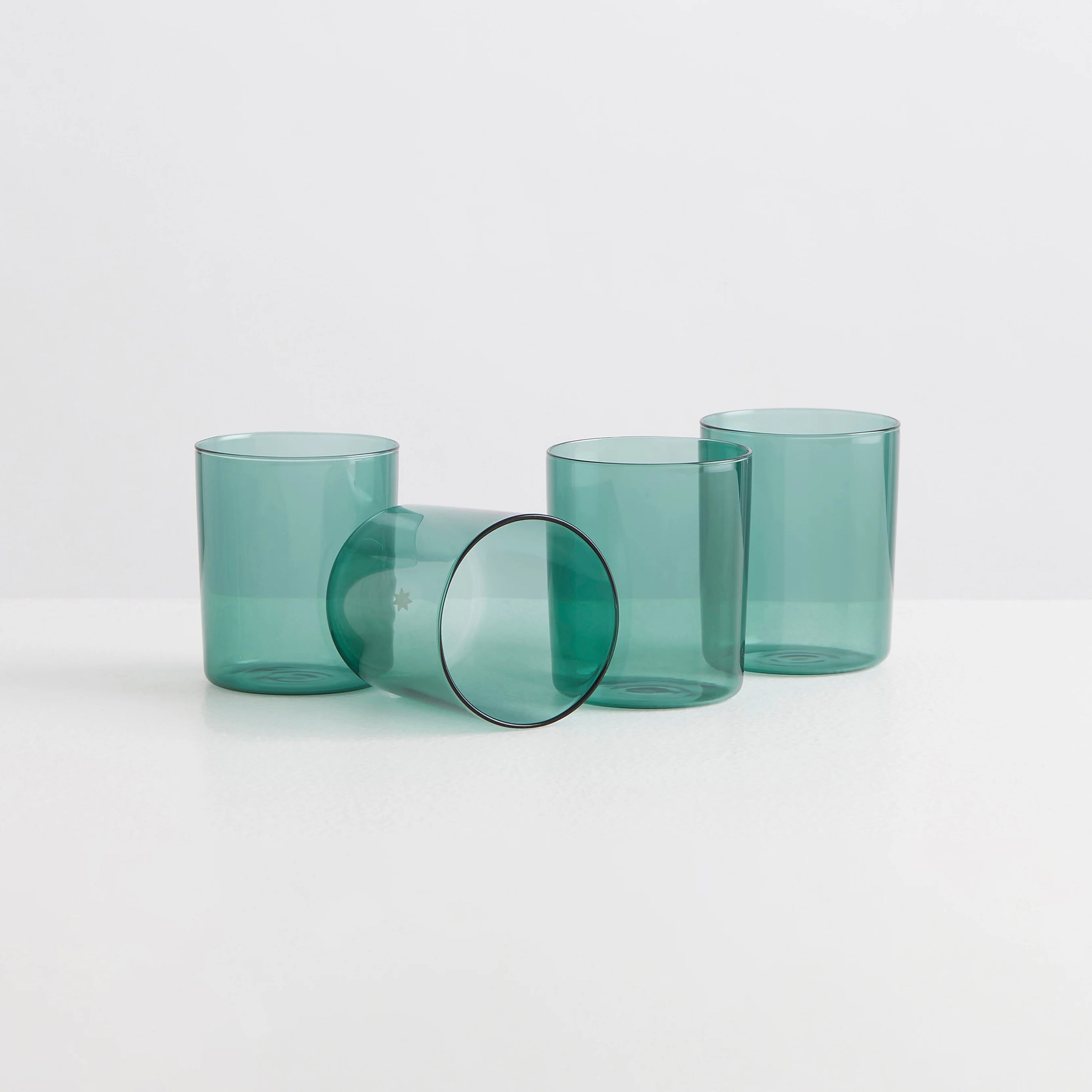 Four teal coloured clear drinking glasses