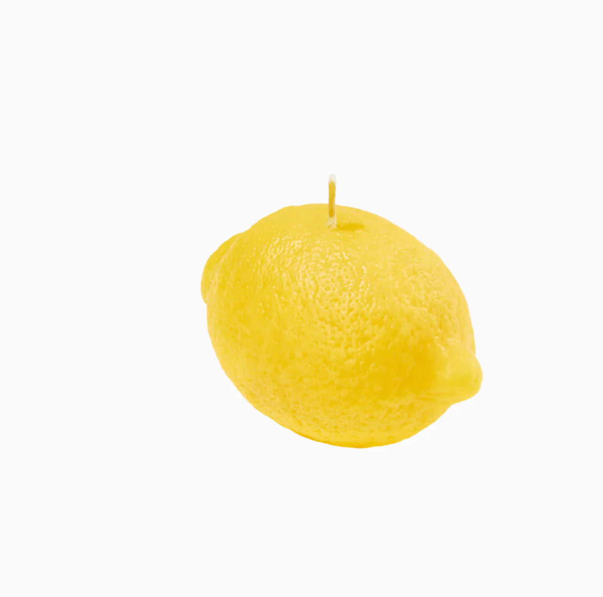 A lemon shaped candle on a white background