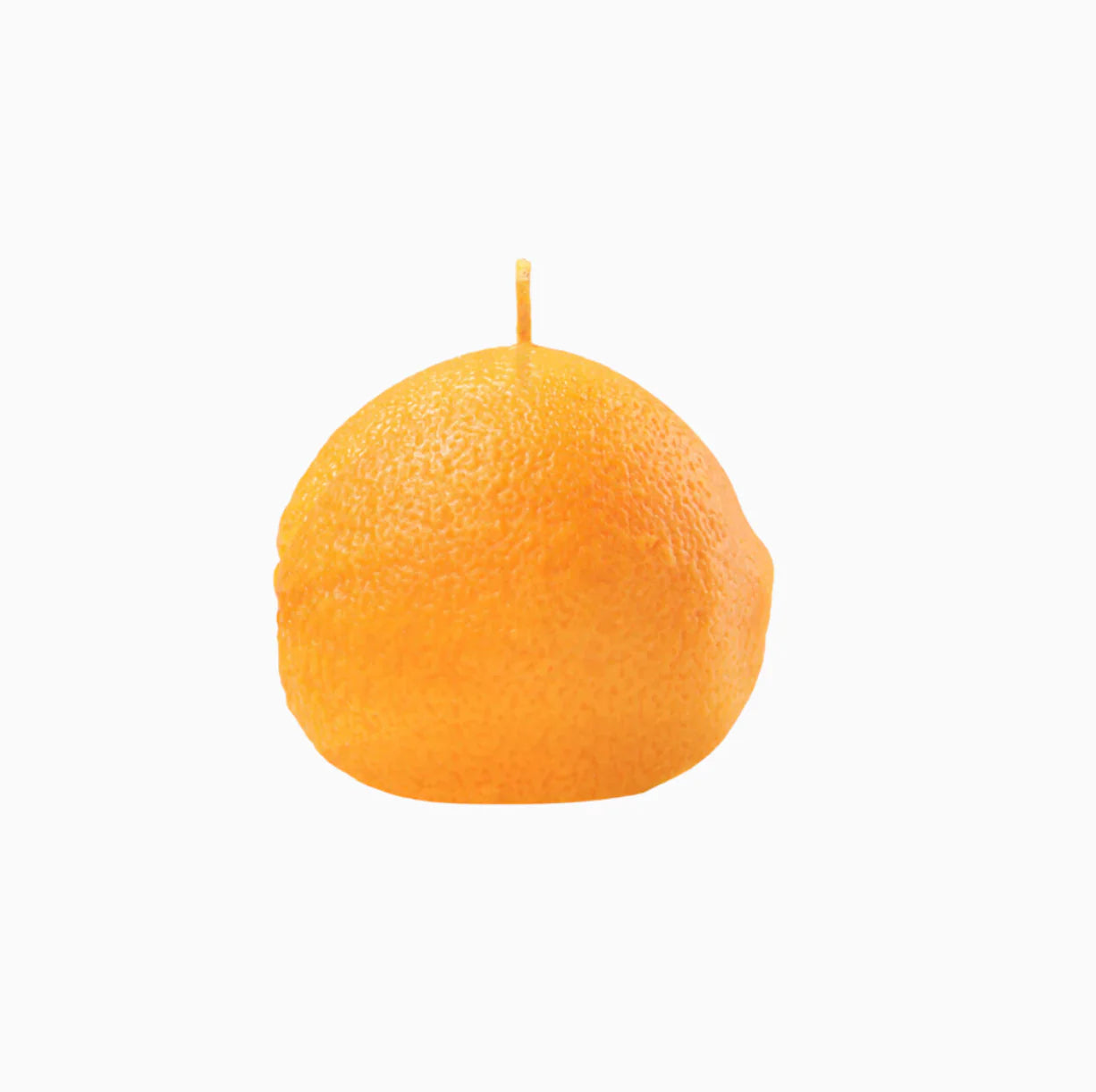 An orange shaped candle on a white background